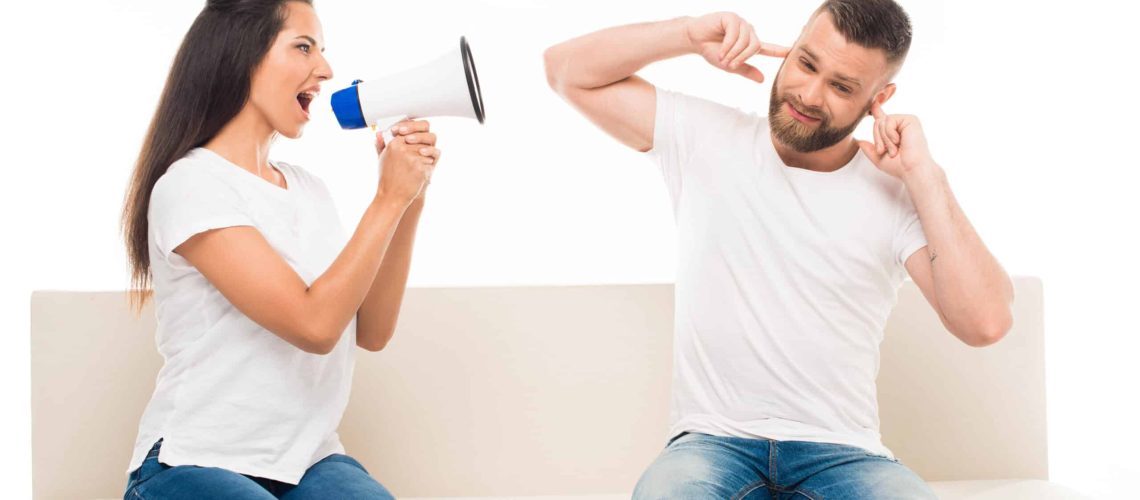 Woman yelling at man with a megaphone